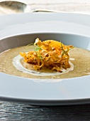 Cream of parsnip soup garnished with fried parsnips