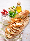Ingredients for bruschetta: bread, mozzarella, tomatoes and artichokes