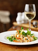 Garlic prawns with lamb's lettuce and a glass of white wine