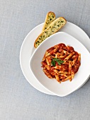 Penne with tomato sauce and garlic bread (seen from above)