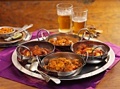 Four different types of curries on a tray (India)