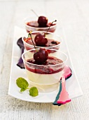 Panna cotta with a berry and cherry sauce in bowls