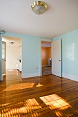 Empty room in apartment with hardwood floor