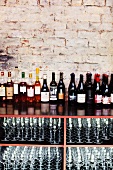 Various bottles of wine and empty glasses in a restaurant
