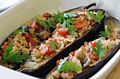 Aubergines filled with rice, tomatoes and pork