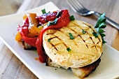 Bruschetta topped with grilled tomino cheese and peppers