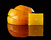 A stack of orange slices and a cube of fruit flesh