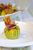 Stuffed courgette flowers tied with strips of bacon