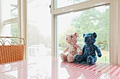 Two hand-made teddy bears in window