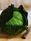 A savoy cabbage on a chopping board