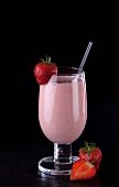 A strawberry smoothie with fresh strawberries