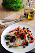 Pan fried fillets of John Dory with baby plum tomatoes and black olives and capers