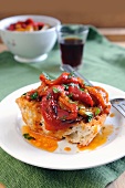 Sweet red and yellow peppers in a spicy chili sauce on a bruschetta