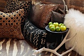 Decorative throw pillows antlers and apples on bed