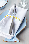 Fish-shaped place setting with plaited cord napkin ring