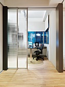 Modern foyer with open sliding glass door and view of office beyond