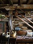 Rustic staircase with old wood-beamed ceiling, antique lantern and rustic wooden bench