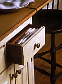 Open drawer in vintage kitchen cupboard