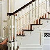 White, Georgian staircase with wooden treads and stair runner