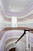 Stairwell with pattern of stripes on curved walls