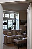 View through doorway of sofa in rustic living room