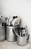 Old cutlery in aluminium cups