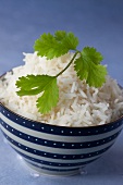 A bowl of cooked rice garnish with coriander