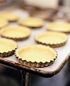 Unbaked Mini Tart Shells on Baking Sheet