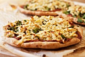 Gluten Free Vegan Pizza Topped with Rosemary and Oregano, Marinara Sauce, Pine Nuts, Kalamata Olives, Spinach, Shredded Cashew Cheese