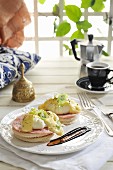 Eggs Benedict: toast topped with ham and poached eggs, with hollandaise sauce