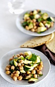 Plates of Chickpea and Zucchini Salad with Pita Breads