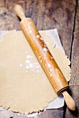 Rolled-out spelt dough with a rolling pin
