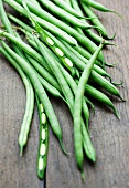 Green beans on a wooden background