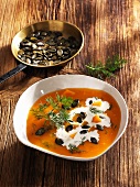 Cream of pumpkin soup with pumpkin seeds and dill