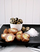 Scotch eggs (egg wrapped in sausage meat and coated in breadcrumbs, England)