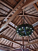 Detail wooden beamed ceiling with old fashioned lighting fixture