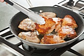 Browning Chicken in a Skillet; Flipping with Tongs