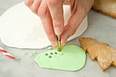 Biscuit decorations being cut out of fondant