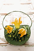 Courgettes with courgette flowers in a basket