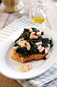Bruschetta topped with black cabbage and white beans