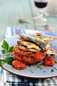 Crostini topped with sardines and tomatoes