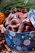 Chocolate coated gingerbread in a Christmas tin