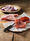 Sliced cured meats with red onion