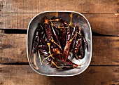 Dried Red Peppers in a Pewter Bowl on Wood