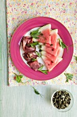 Watermelon with beef and pumpkin seeds