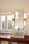 Stone sink on wooden countertop in bathroom