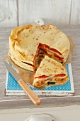 Pancake tart with cheese and vegetables, sliced