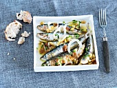 Marinated sardines with onions and pine nuts
