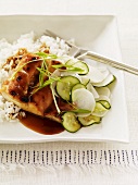 Glazed Chicken with Sliced Cucumbers and Parsnips Over Rice; In a Square Bowl with a Fork
