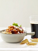Vegetable Chili Served Over Rice with Tortilla Chips and a Glass of Beer